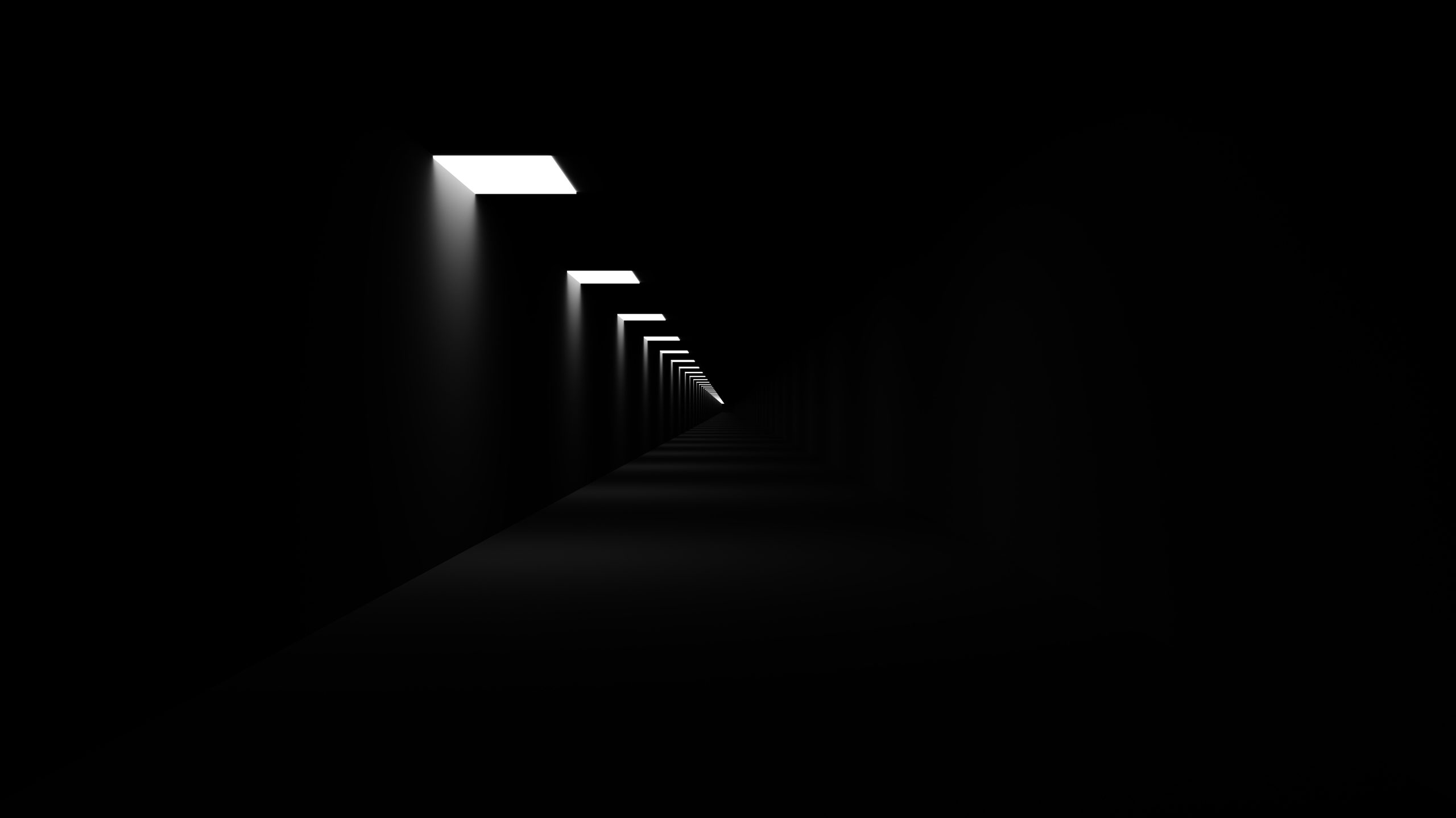 A dark corridor lit only by small ceiling panels receding into the distance