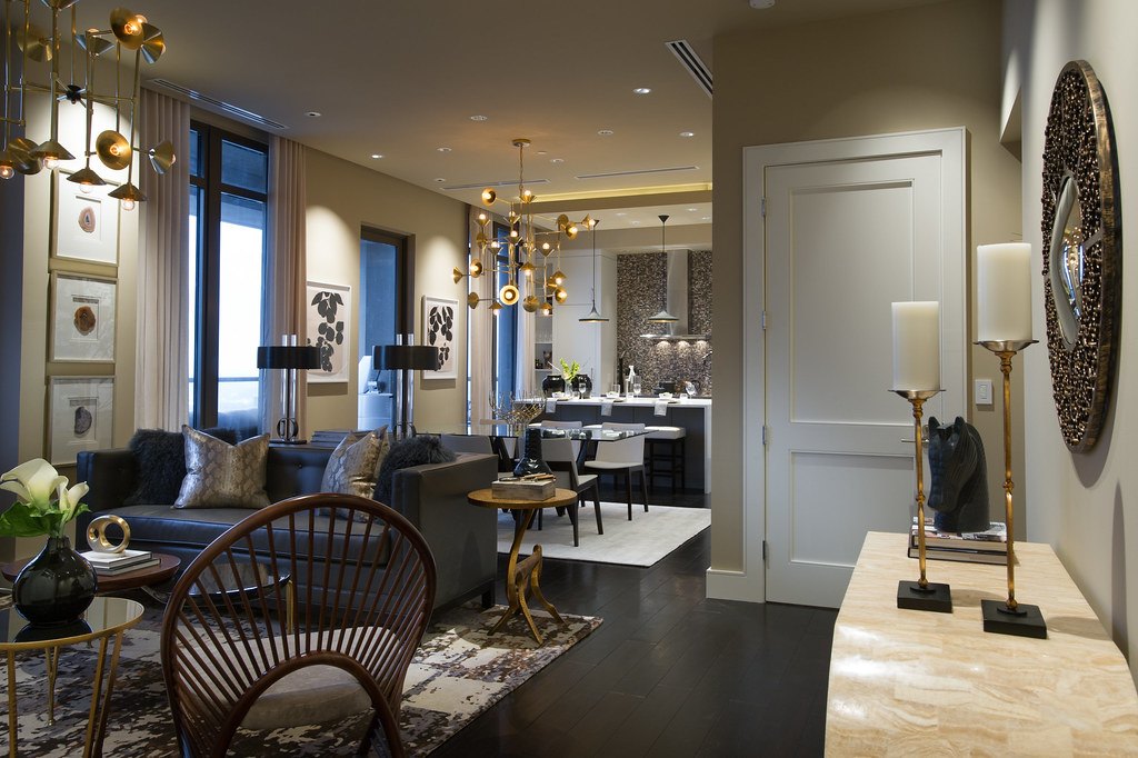 An interior sitting area with a closed white panelled door and lamps